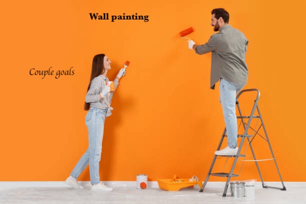 Couple painting wall